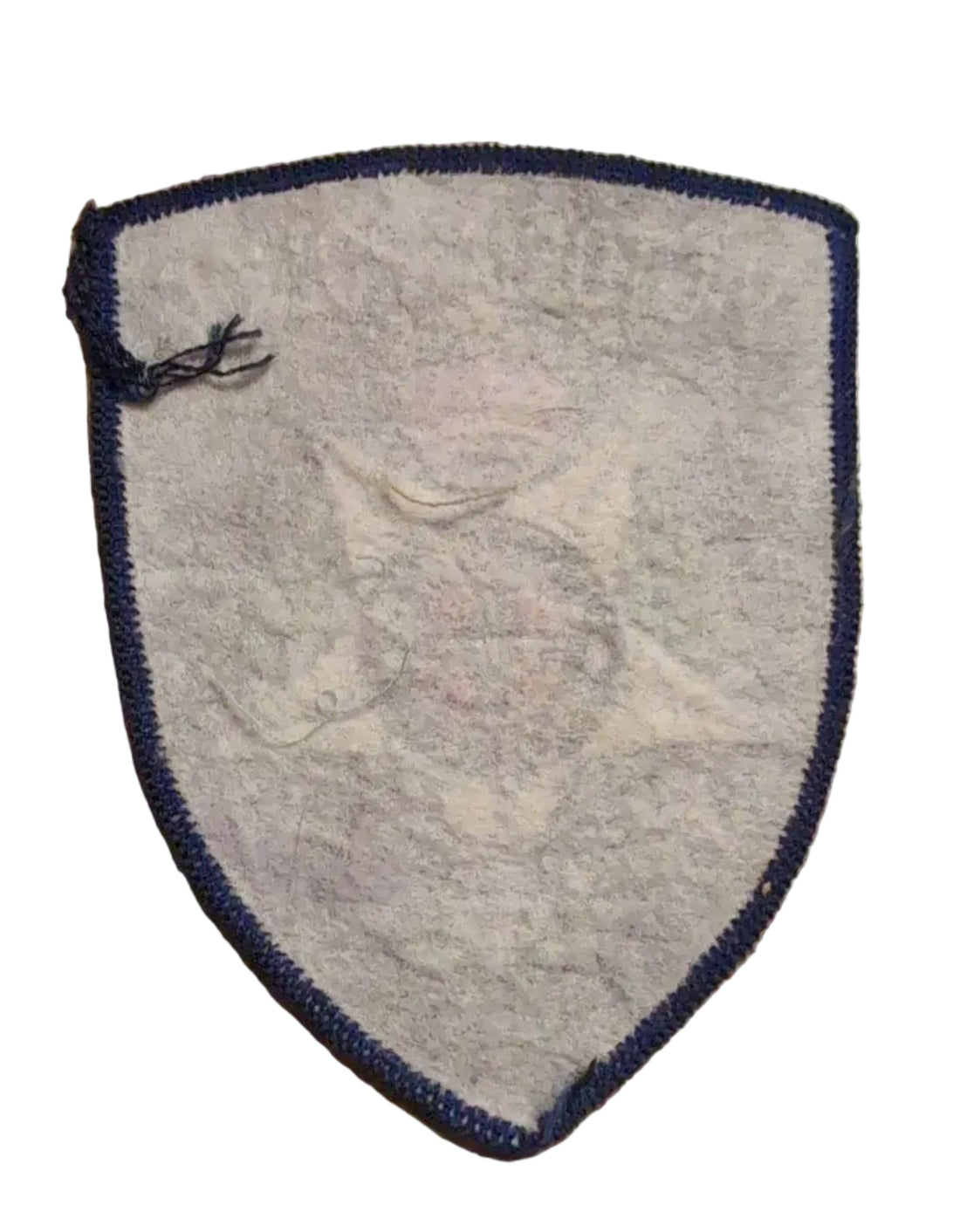 An embroidered Victoria Police badge patch on a wooden surface next to a ruler for scale.