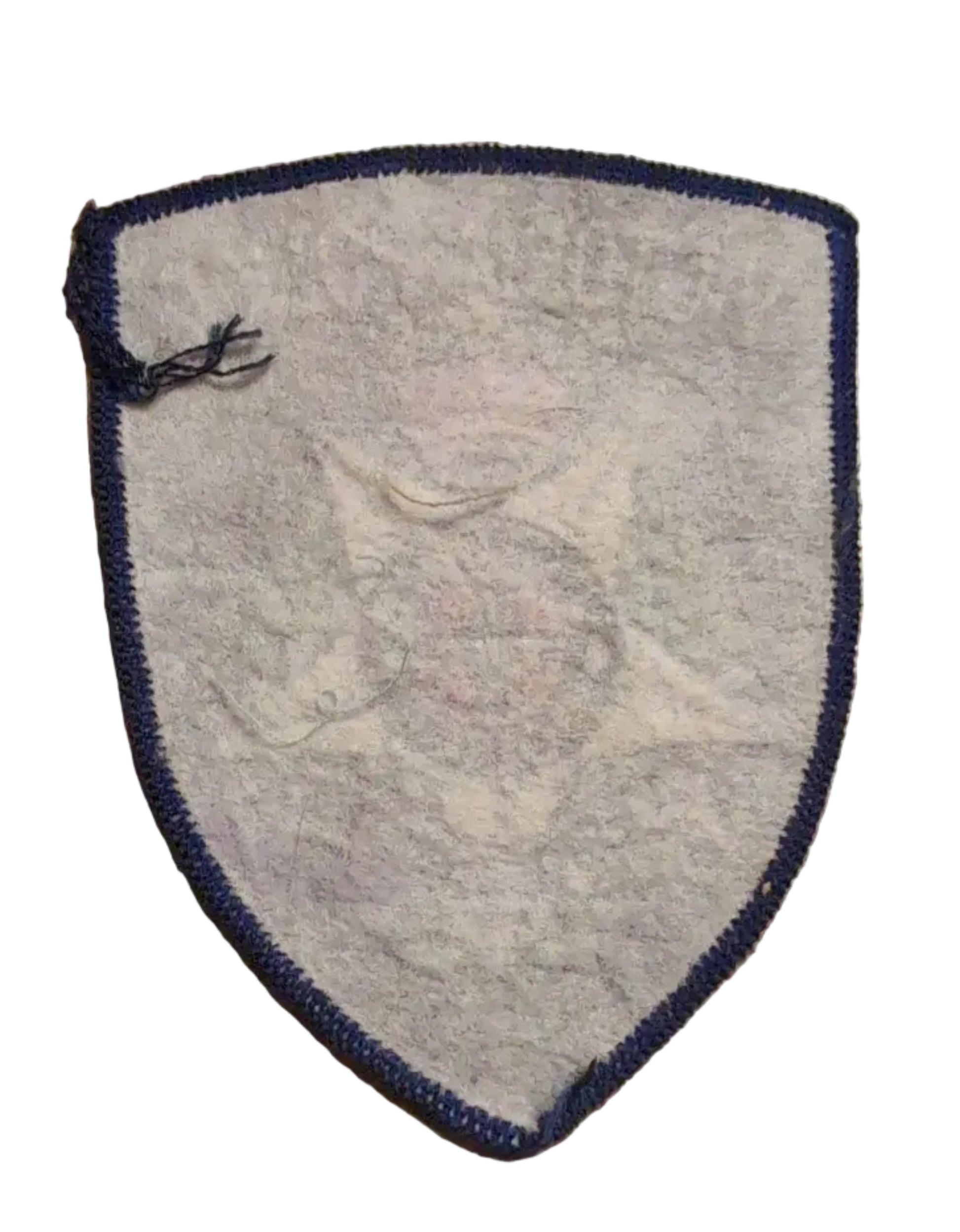rear of An embroidered Victoria Police badge patch on a wooden surface next to a ruler for scale.