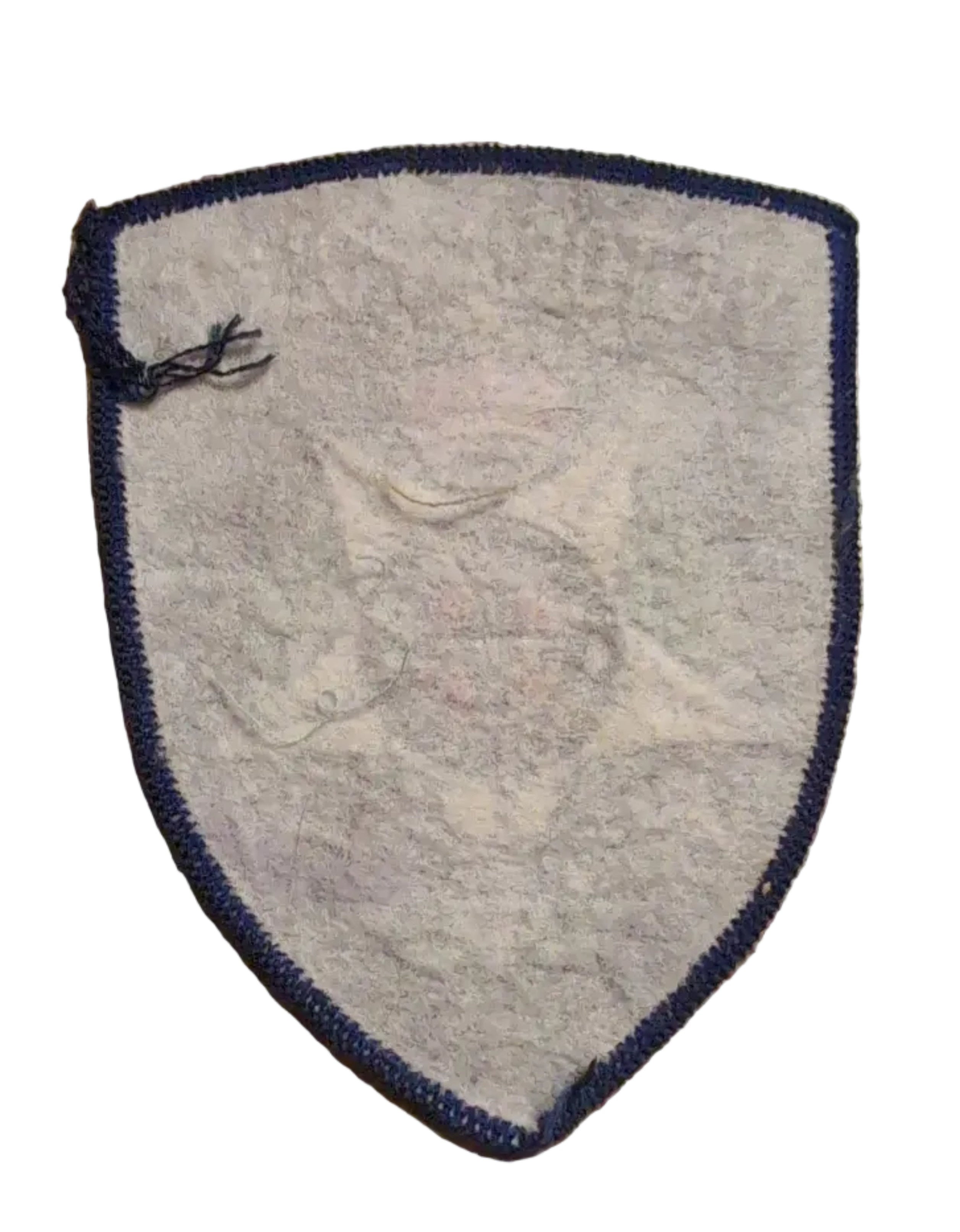 rear of An embroidered Victoria Police badge patch on a wooden surface next to a ruler for scale.