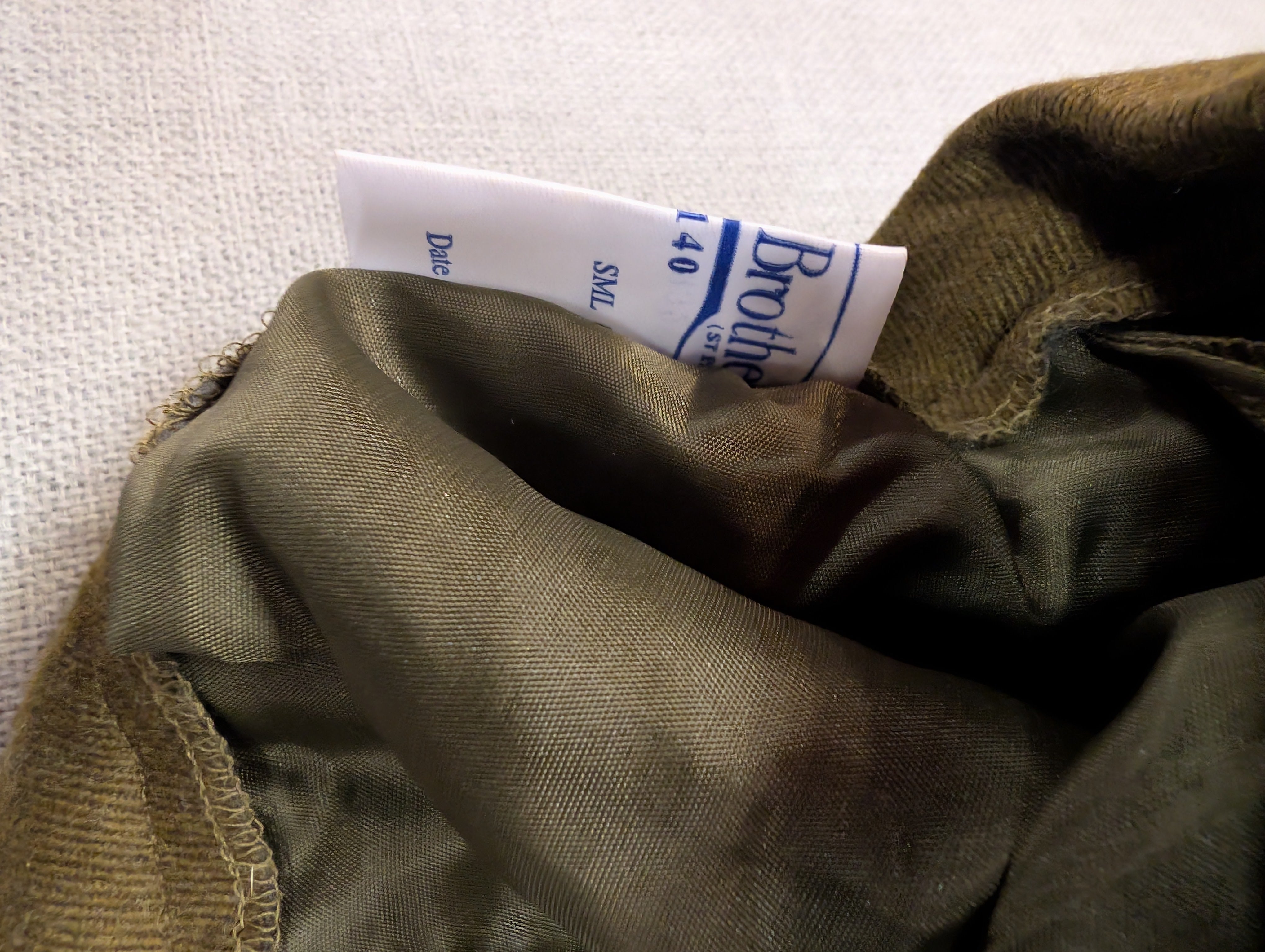 Close-up of a satin-garment interior with a white fabric brand label reading Samuel Brothers Bespoke Tailors on a 1980s Pattern British Army Officers No2 Service Dress Uniform Skirt