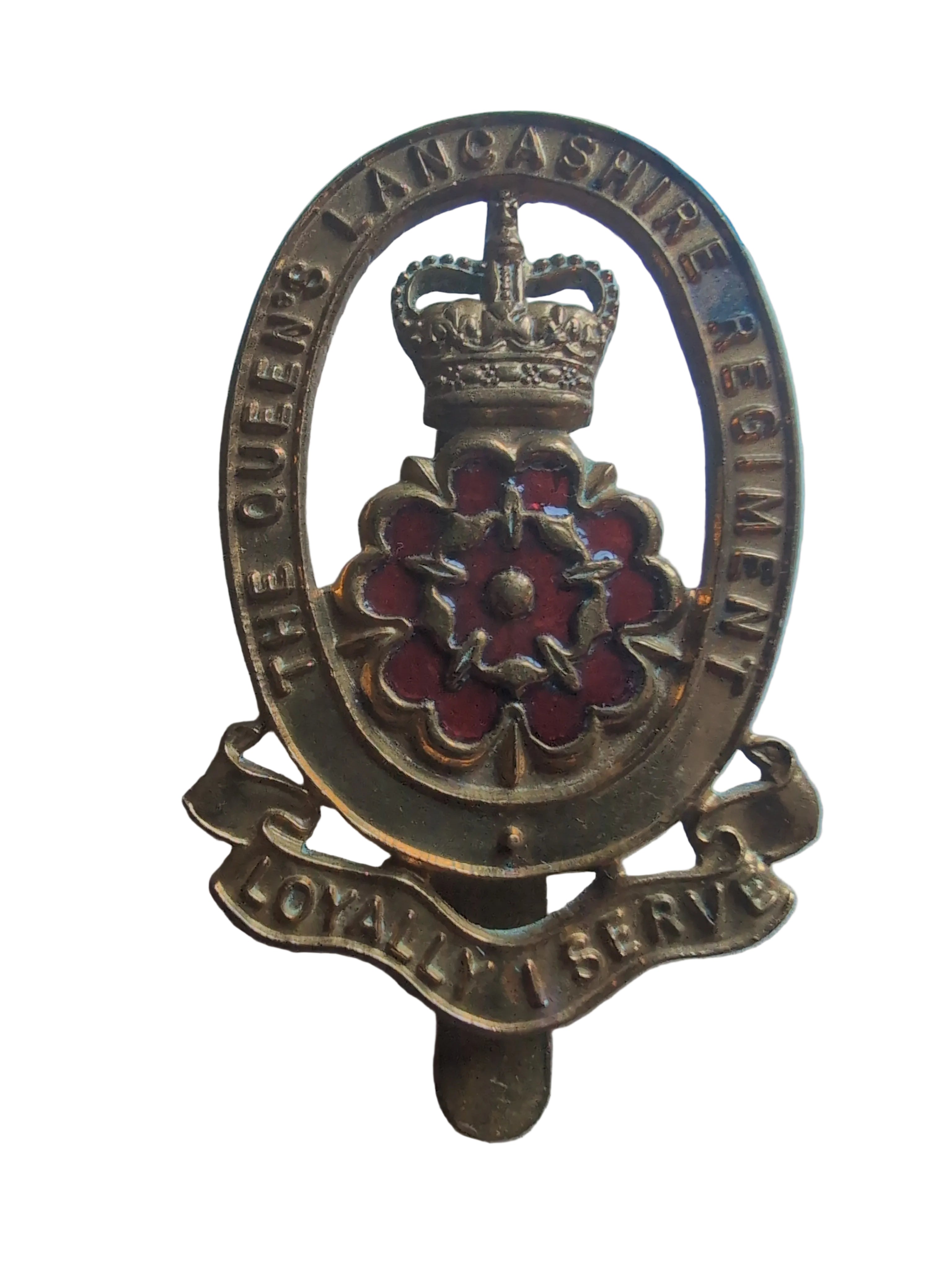 A vintage brass military badge for The Queen's Lancashire Regiment, featuring a crown, red enamel floral motif, and a scroll reading 'Loyalty and Service'.