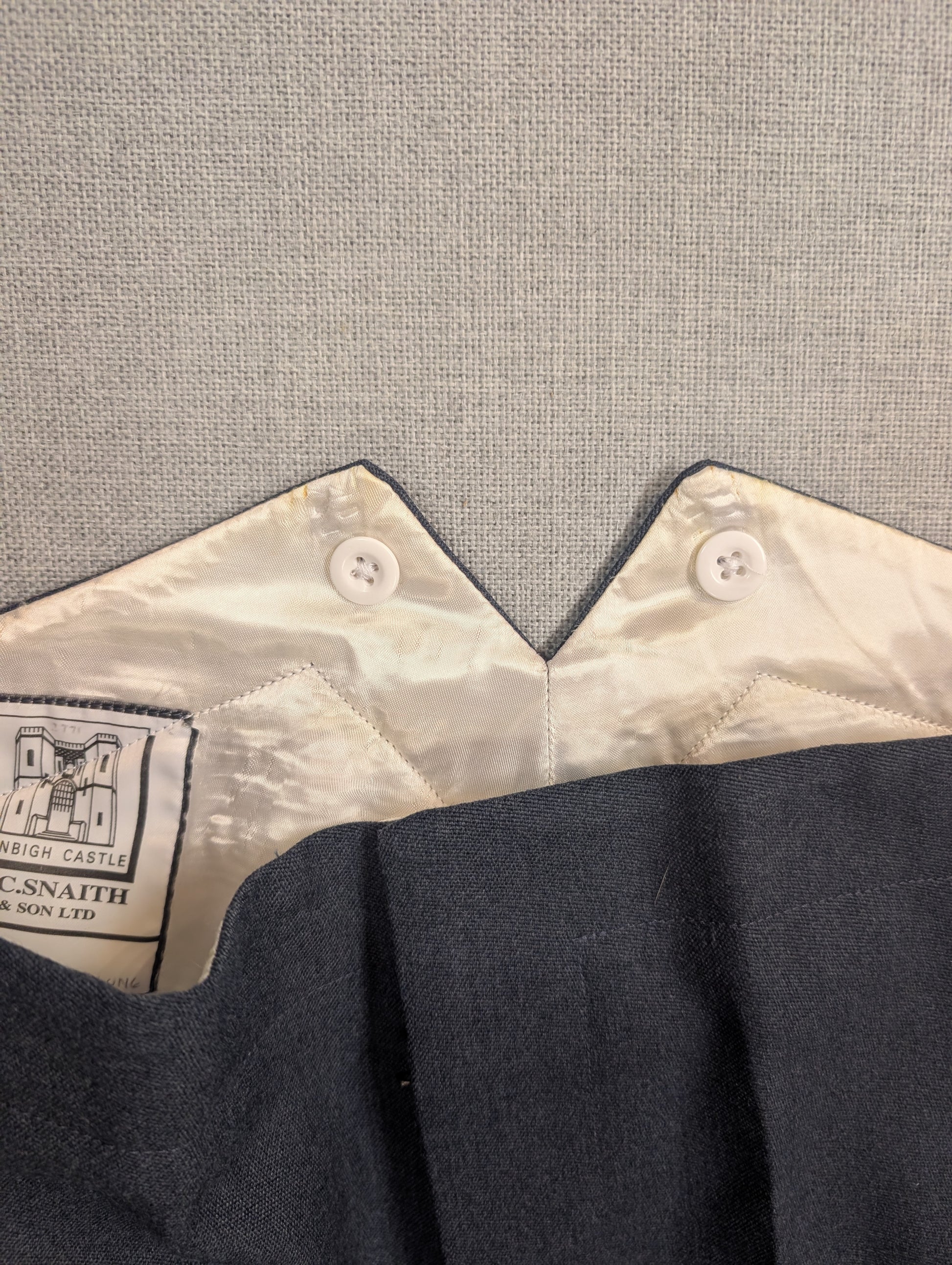 Close up photo of fishtailed RAF No5 Mess Dress Trousers with sewn in buttons buttons for button on braces