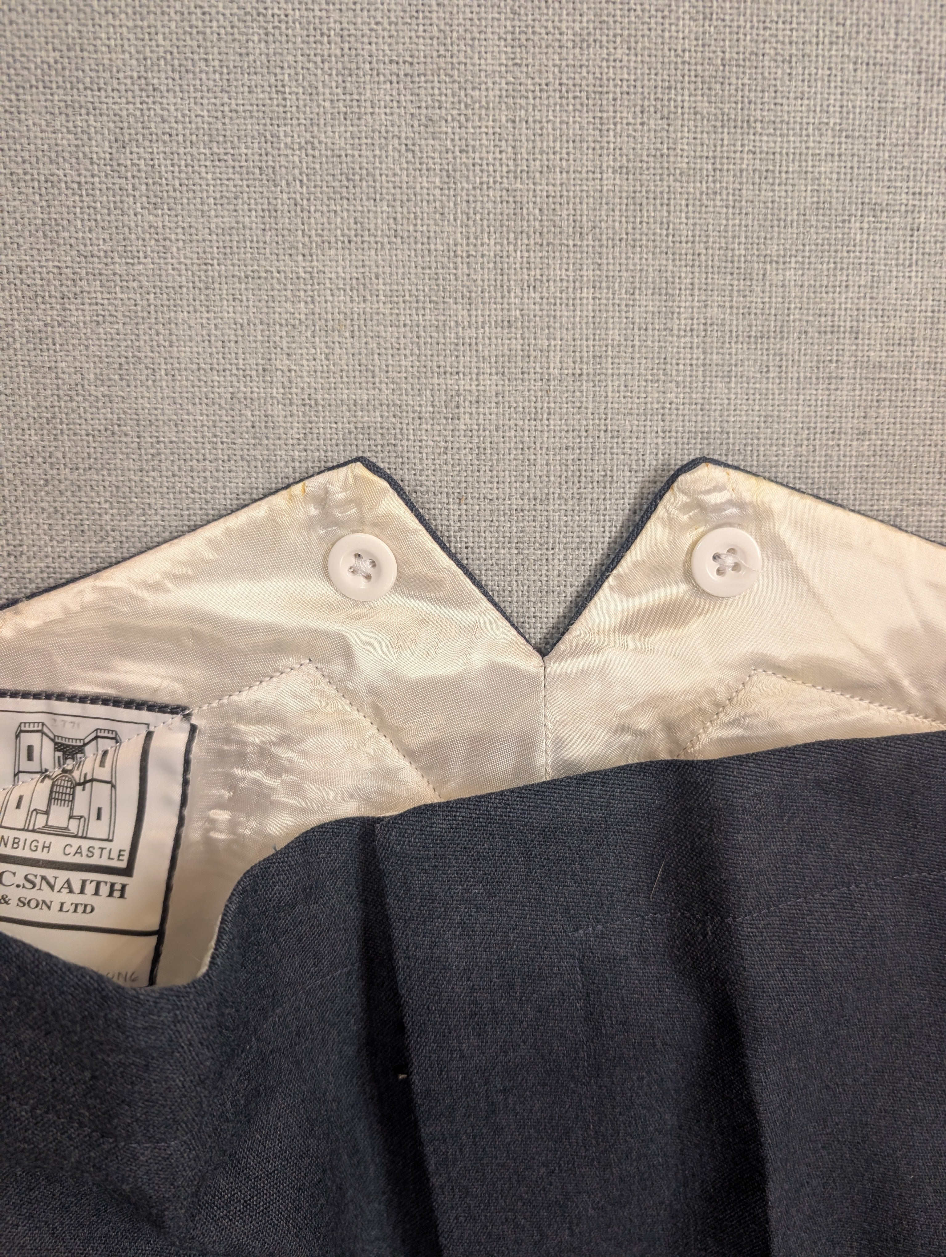 Close up photo of fishtailed RAF No5 Mess Dress Trousers with sewn in buttons buttons for button on braces
